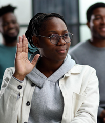 A woman raises her hand